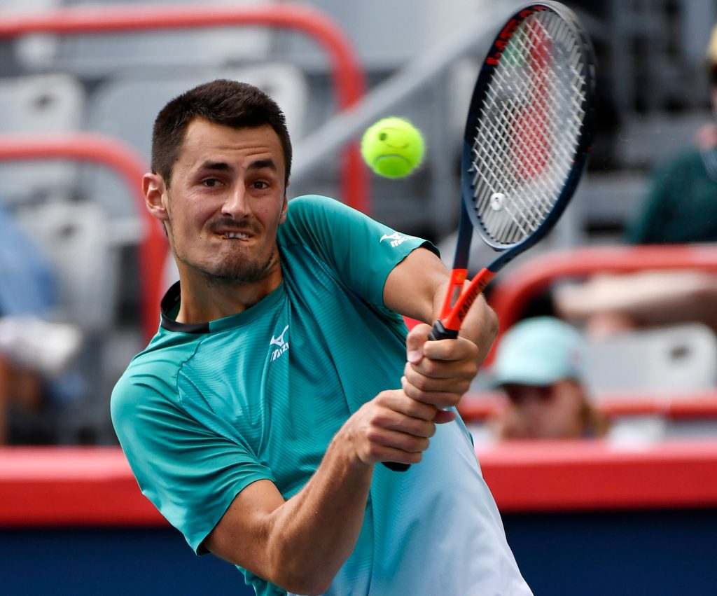 Aug 4, 2019; Montreal, Quebec, Canada; Bernard Tomic of Australia plays a shot against Marc Polmans of Australia (not pictured) during the Rogers Cup tennis tournament at Stade IGA. Mandatory Credit: Eric Bolte-Imagn Images