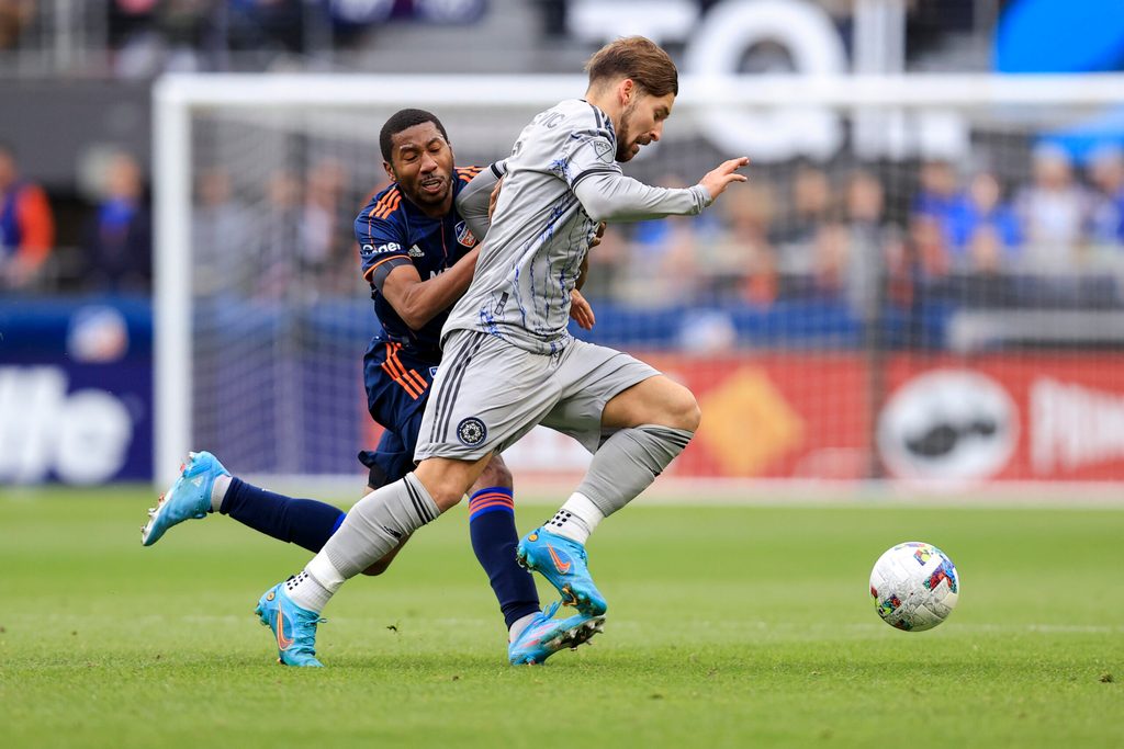 Apr 2, 2022; Cincinnati, Ohio, USA; CF Montreal midfielder Matko Miljevic (right) controls the ball against FC Cincinnati defender Ray Gaddis (28) in the second half at TQL Stadium. Mandatory Credit: Aaron Doster-Imagn Images