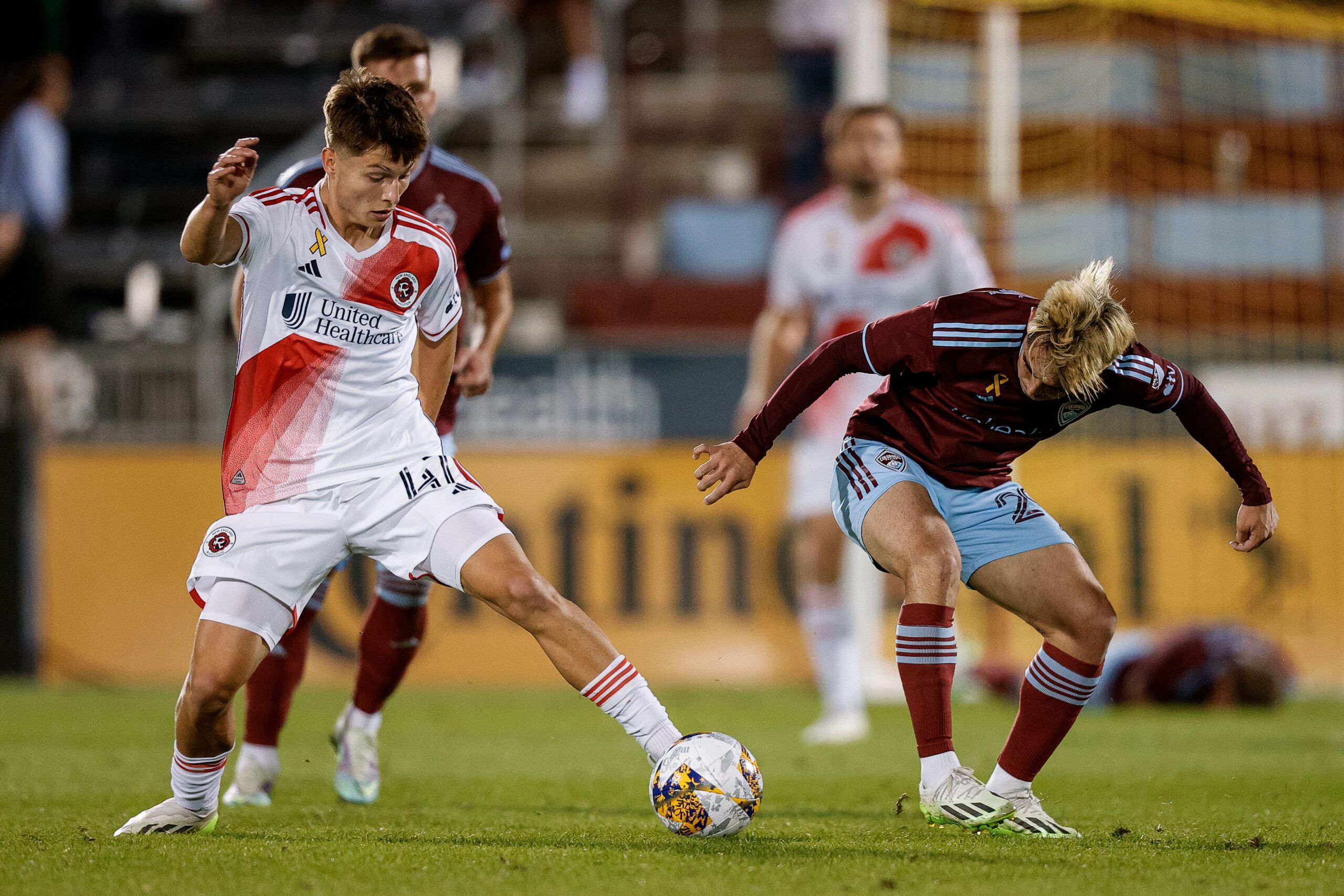 Sep 16, 2023; Commerce City, Colorado, USA; New England Revolution forward Esmir Bajraktarevic (47) controls the ball as Colorado Rapids midfielder Braian Galvan (29) defends in the second half at Dick's Sporting Goods Park. Mandatory Credit: Isaiah J. Downing-Imagn Images