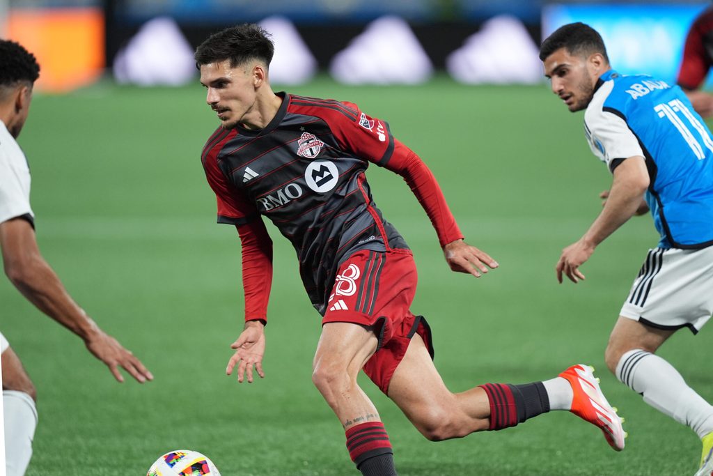 Apr 13, 2024; Charlotte, North Carolina, USA; Toronto FC defender Raoul Petretta (28) plays the ball in the first half against the Charlotte FC at Bank of America Stadium. Mandatory Credit: Jim Dedmon-Imagn Images