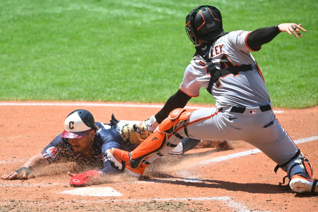 Jul 7, 2024; Cleveland, Ohio, USA; Cleveland Guardians first baseman Josh Naylor (22) is tagged out at home plate by San Francisco Giants catcher Patrick Bailey (14) in the fourth inning at Progressive Field. Mandatory Credit: David Richard-Imagn Images
