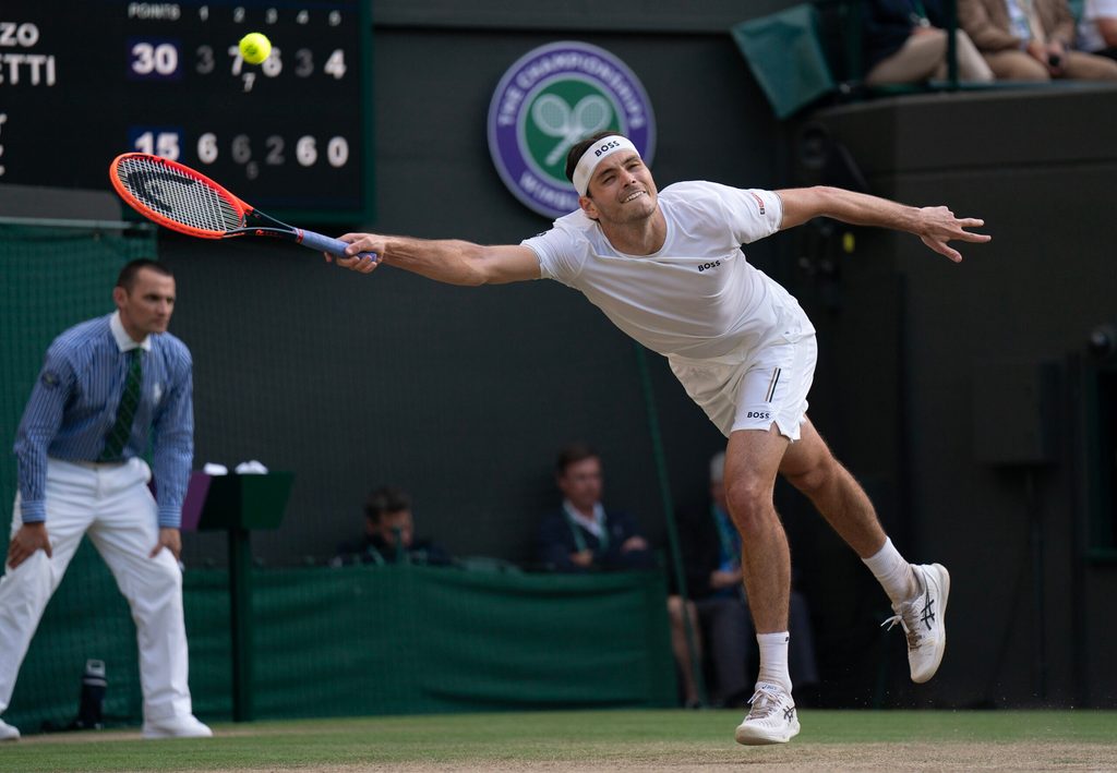 Jul 10, 2024; London, United Kingdom; Taylor Fritz of the United States returns a shot during his match against Lorenzo Musetti of Italy (not shown) on day 10 at All England Lawn Tennis and Croquet Club. Mandatory Credit: Susan Mullane-Imagn Images