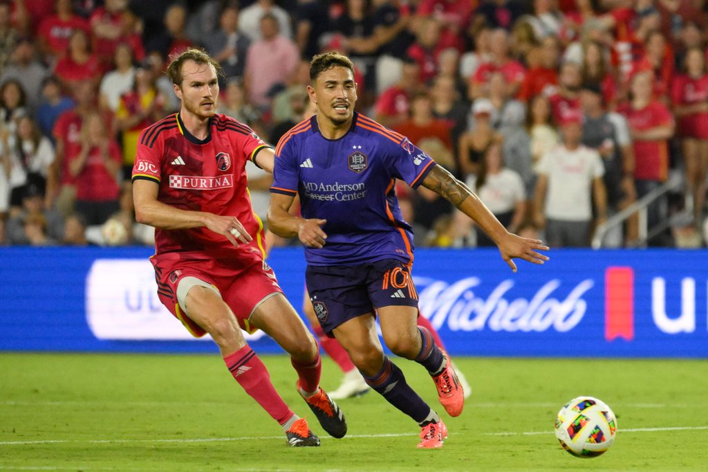 Oct 5, 2024; St. Louis, Missouri, USA; St. Louis CITY SC defender Henry Kessler (5) and Houston Dynamo FC forward Ezequiel Ponce (10) battle for the ball in the second half at CITYPARK. Mandatory Credit: Jeff Le-Imagn Images