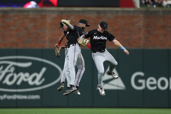 Apr 5, 2025; Cumberland, Georgia, USA; Miami Marlins outfielder Kyle Stowers (28), Miami Marlins outfielder Griffin Conine (18) and Miami Marlins outfielder Derek Hill (3) celebrate the win against the Atlanta Braves at Truist Park. Mandatory Credit: Mady Mertens-Imagn Images