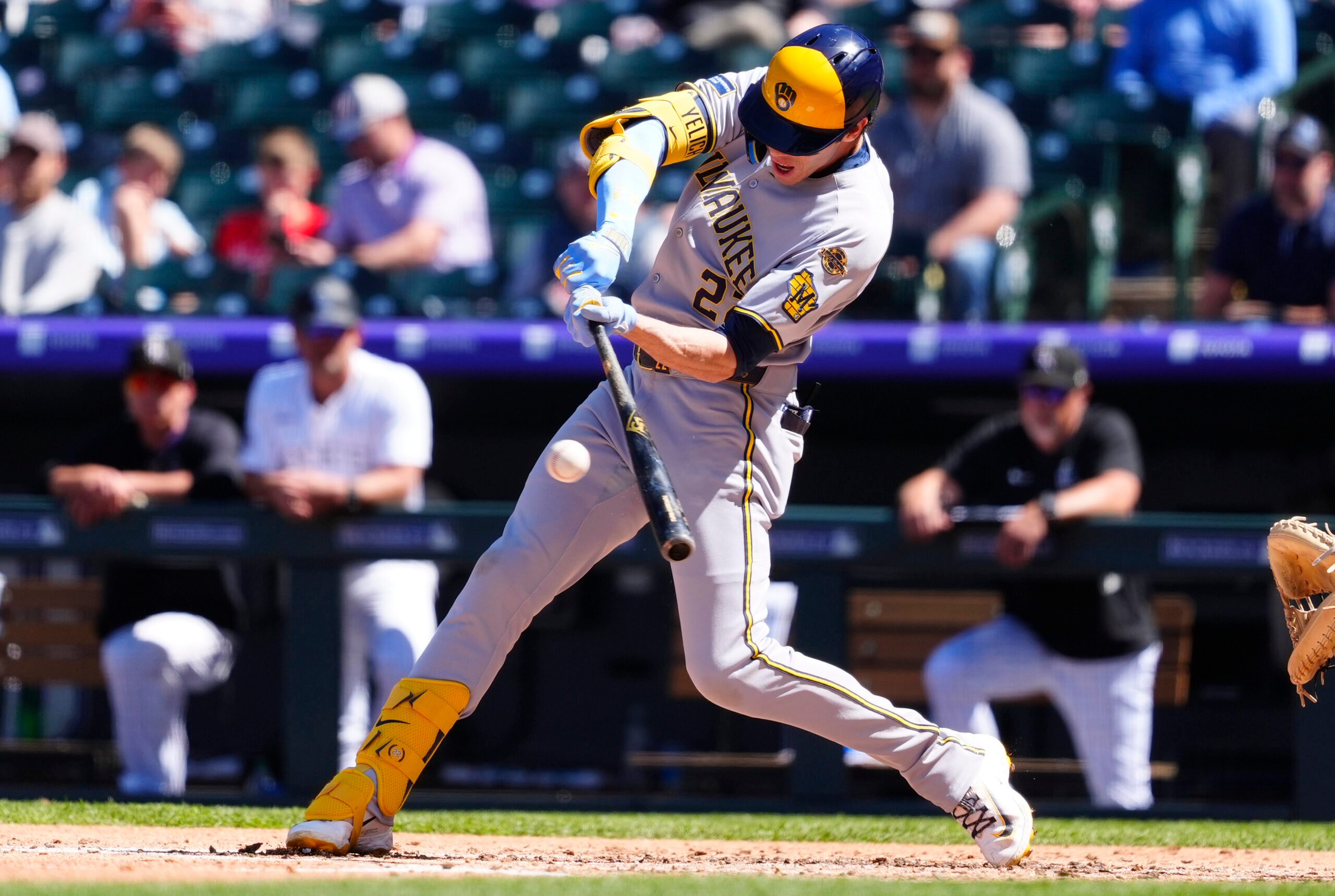 Apr 10, 2025; Denver, Colorado, USA; Milwaukee Brewers outfielder Christian Yelich (22) doubles in the fourth inning against the Colorado Rockies at Coors Field. Mandatory Credit: Ron Chenoy-Imagn Images