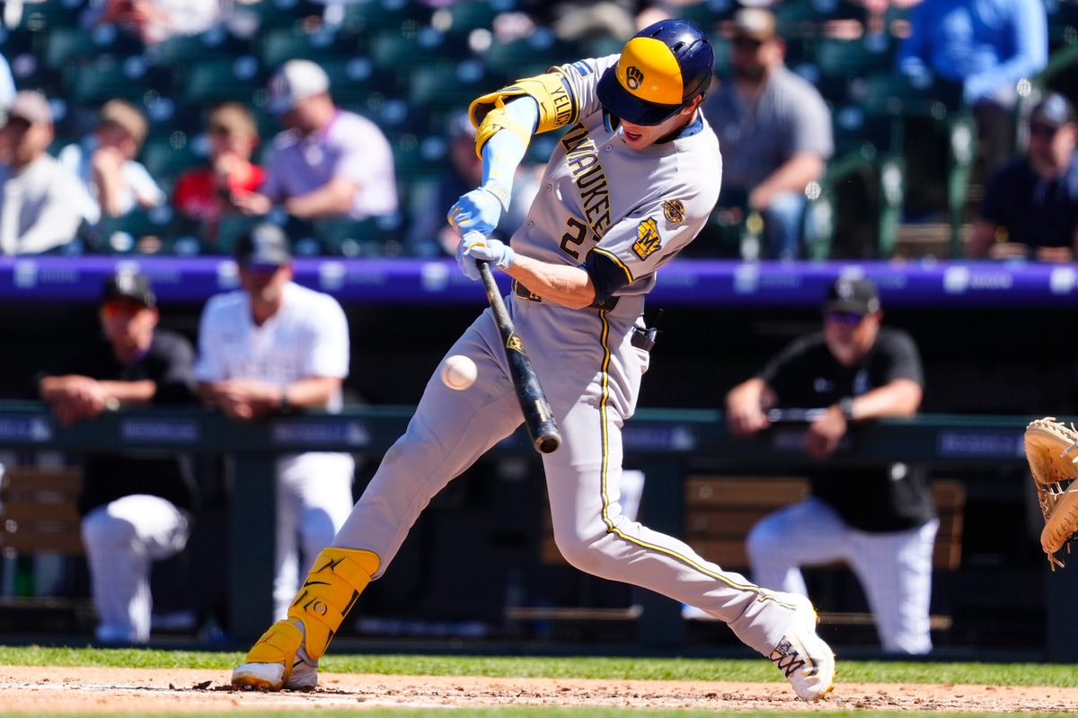 Apr 10, 2025; Denver, Colorado, USA; Milwaukee Brewers outfielder Christian Yelich (22) doubles in the fourth inning against the Colorado Rockies at Coors Field. Mandatory Credit: Ron Chenoy-Imagn Images