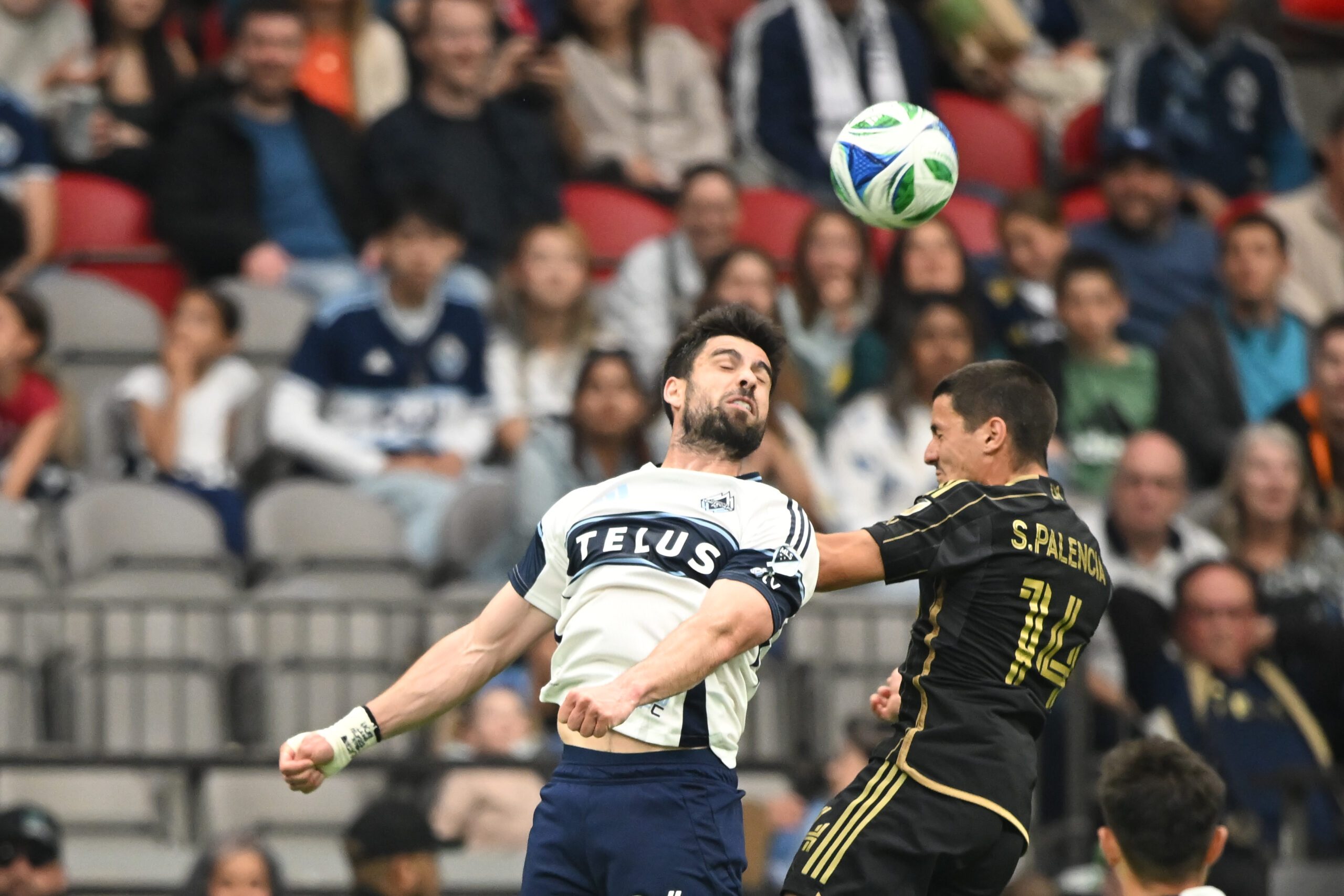 May 11, 2025; Vancouver, British Columbia, CAN;  Vancouver Whitecaps FC forward Brian White (24) guhagainst Los Angeles FC defender Sergi, Palencia (14) during the second half at BC Place. Mandatory Credit: Anne-Marie Sorvin-Imagn Images