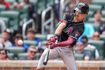 Jun 5, 2025; Cumberland, Georgia, USA; Arizona Diamondbacks right fielder Corbin Carroll (7) doubles against the Atlanta Braves during the ninth inning at Truist Park. Mandatory Credit: Dale Zanine-Imagn Images