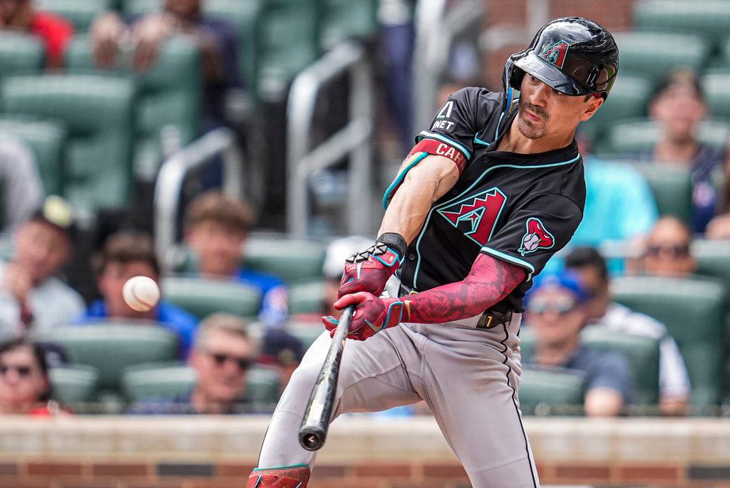 Jun 5, 2025; Cumberland, Georgia, USA; Arizona Diamondbacks right fielder Corbin Carroll (7) doubles against the Atlanta Braves during the ninth inning at Truist Park. Mandatory Credit: Dale Zanine-Imagn Images
