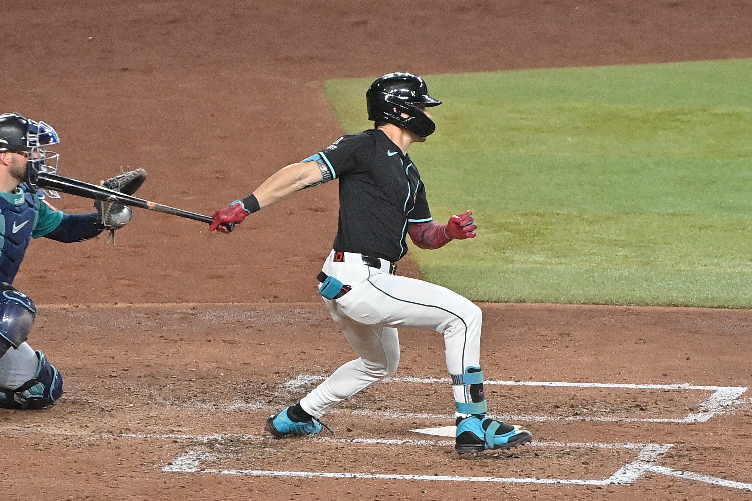 Jun 11, 2025; Phoenix, Arizona, USA;  Arizona Diamondbacks outfielder Corbin Carroll (7) singles in in the sixth inning against the Seattle Mariners at Chase Field. Mandatory Credit: Matt Kartozian-Imagn Images