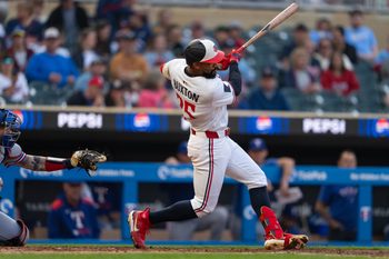 Jun 11, 2025; Minneapolis, Minnesota, USA; Minnesota Twins center fielder Byron Buxton (25) hits a double during the fifth inning against the Texas Rangers at Target Field. Mandatory Credit: Jordan Johnson-Imagn Images