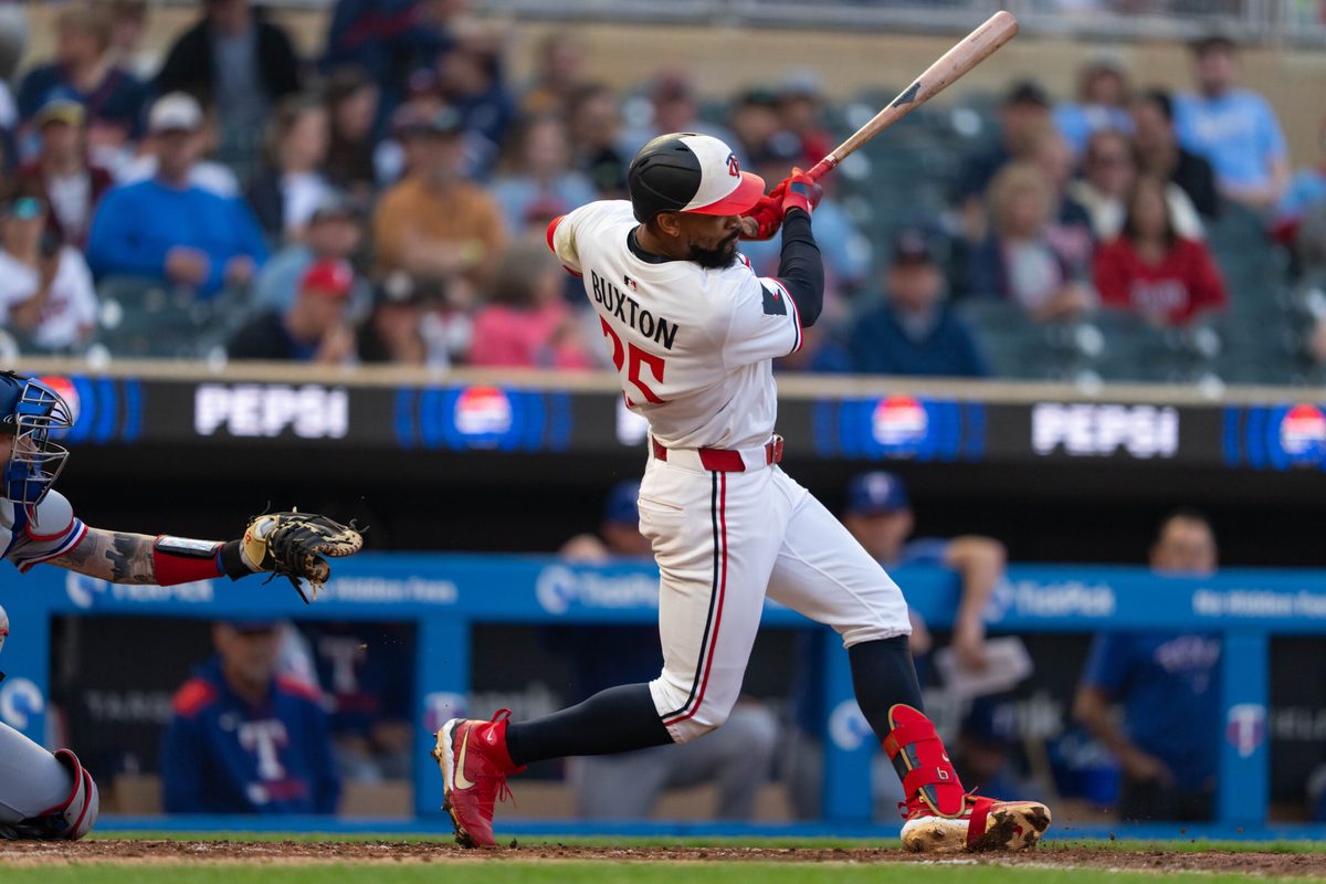 Jun 11, 2025; Minneapolis, Minnesota, USA; Minnesota Twins center fielder Byron Buxton (25) hits a double during the fifth inning against the Texas Rangers at Target Field. Mandatory Credit: Jordan Johnson-Imagn Images