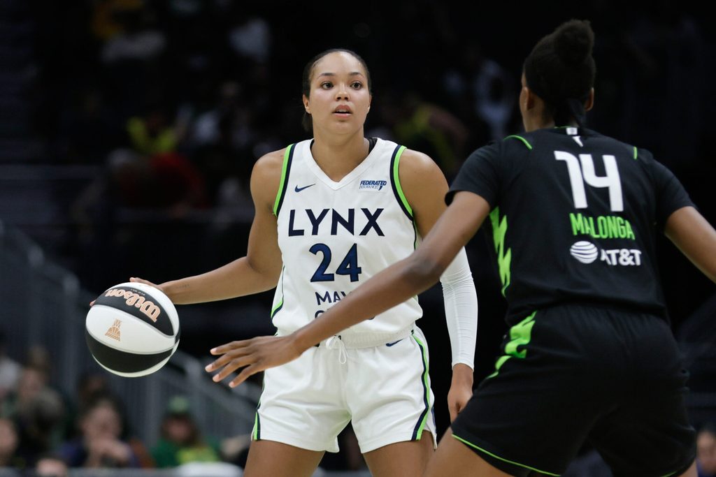 Jun 11, 2025; Seattle, Washington, USA; Minnesota Lynx forward Napheesa Collier (24) dribbles with Seattle Storm center Dominique Malonga (14) defending during the second half at Climate Pledge Arena. Mandatory Credit: John Froschauer-Imagn Images