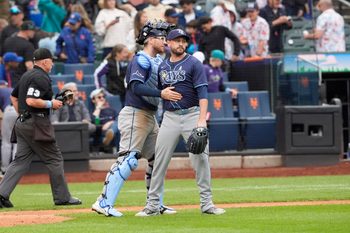 Jun 15, 2025; New York City, New York, USA; Tampa Bay Rays catcher Danny Jansen (19) and pitcher Cole Sulser (71)  celebrate the victory against the New York Mets after the ninth inning at Citi Field. Mandatory Credit: Gregory Fisher-Imagn Images