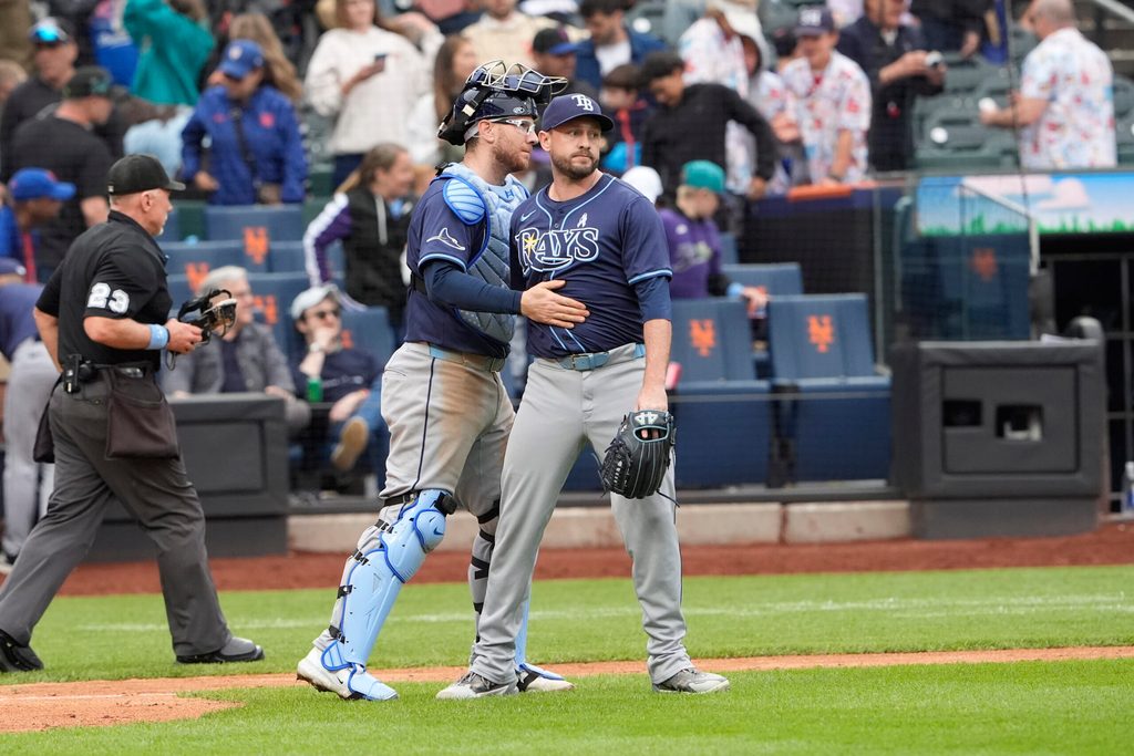 Jun 15, 2025; New York City, New York, USA; Tampa Bay Rays catcher Danny Jansen (19) and pitcher Cole Sulser (71) celebrate the victory against the New York Mets after the ninth inning at Citi Field. Mandatory Credit: Gregory Fisher-Imagn Images