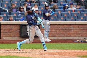 Jun 15, 2025; New York City, New York, USA;  Tampa Bay Rays designated hitter Junior Caminero (13) hits a three run home run against the New York Mets during the ninth inning at Citi Field. Mandatory Credit: Gregory Fisher-Imagn Images