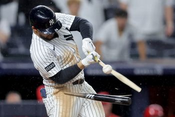 Jun 16, 2025; Bronx, New York, USA; New York Yankees left fielder Jasson Dominguez (24) breaks his bat hitting into a fielder's choice ground ball out during the eleventh inning against the Los Angeles Angels at Yankee Stadium. Mandatory Credit: Brad Penner-Imagn Images