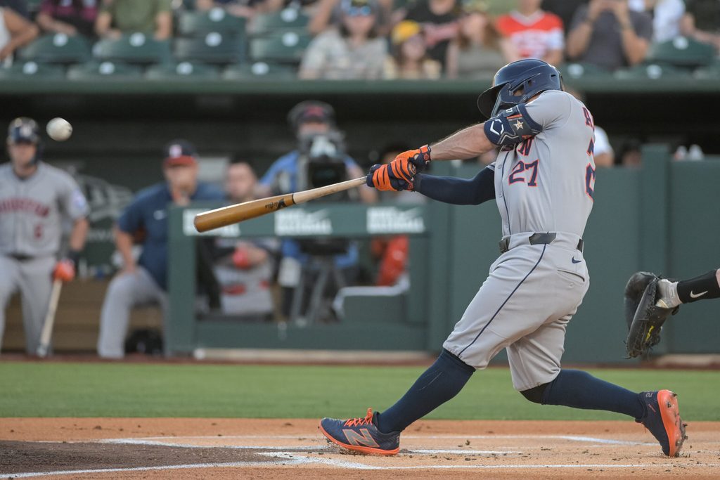Jun 16, 2025; West Sacramento, California, USA; Houston Astros outfielder Jose Altuve (27) hits a home run against the Athletics during the first inning at Sutter Health Park. Mandatory Credit: Ed Szczepanski-Imagn Images