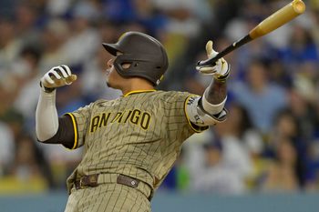 Jun 16, 2025; Los Angeles, California, USA;  San Diego Padres third baseman Manny Machado (13) flips his bat after hitting a solo home run in the sixth inning against the Los Angeles Dodgers at Dodger Stadium. Mandatory Credit: Jayne Kamin-Oncea-Imagn Images