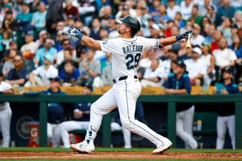 Jun 17, 2025; Seattle, Washington, USA; Seattle Mariners catcher Cal Raleigh (29) hits a grand-slam home run against the Boston Red Sox during the second inning at T-Mobile Park. Mandatory Credit: Joe Nicholson-Imagn Images