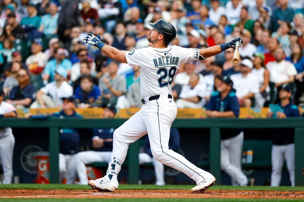 Jun 17, 2025; Seattle, Washington, USA; Seattle Mariners catcher Cal Raleigh (29) hits a grand-slam home run against the Boston Red Sox during the second inning at T-Mobile Park. Mandatory Credit: Joe Nicholson-Imagn Images