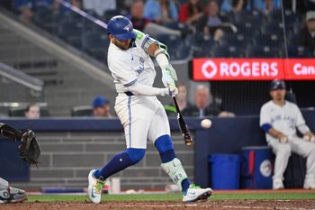 Jun 17, 2025; Toronto, Ontario, CAN;   Toronto Blue Jays shortstop Bo Bichette (11) hits a solo home run against the Arizona Diamondbacks in the ninth inning at Rogers Centre. Mandatory Credit: Dan Hamilton-Imagn Images