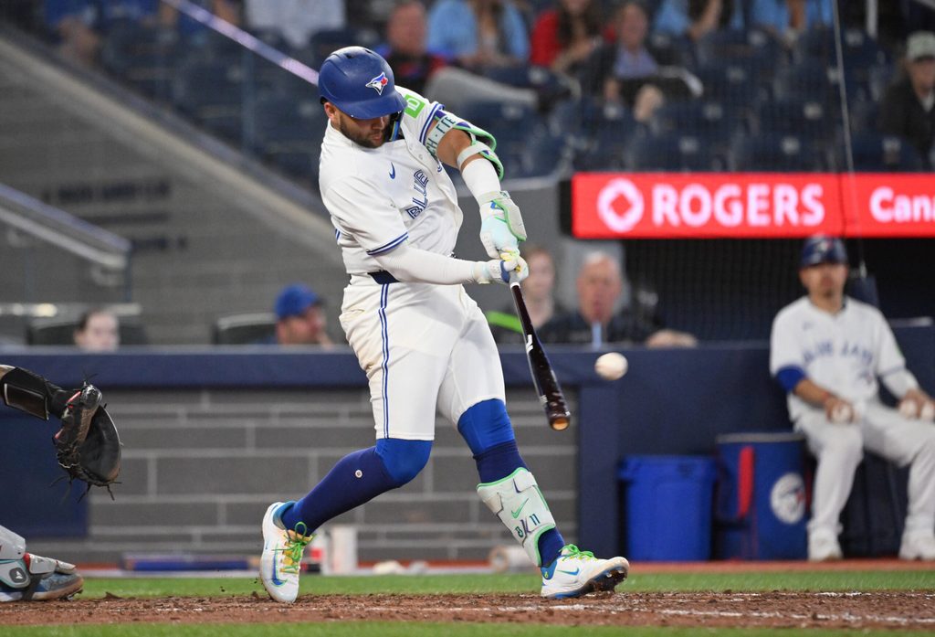 Jun 17, 2025; Toronto, Ontario, CAN; Toronto Blue Jays shortstop Bo Bichette (11) hits a solo home run against the Arizona Diamondbacks in the ninth inning at Rogers Centre. Mandatory Credit: Dan Hamilton-Imagn Images