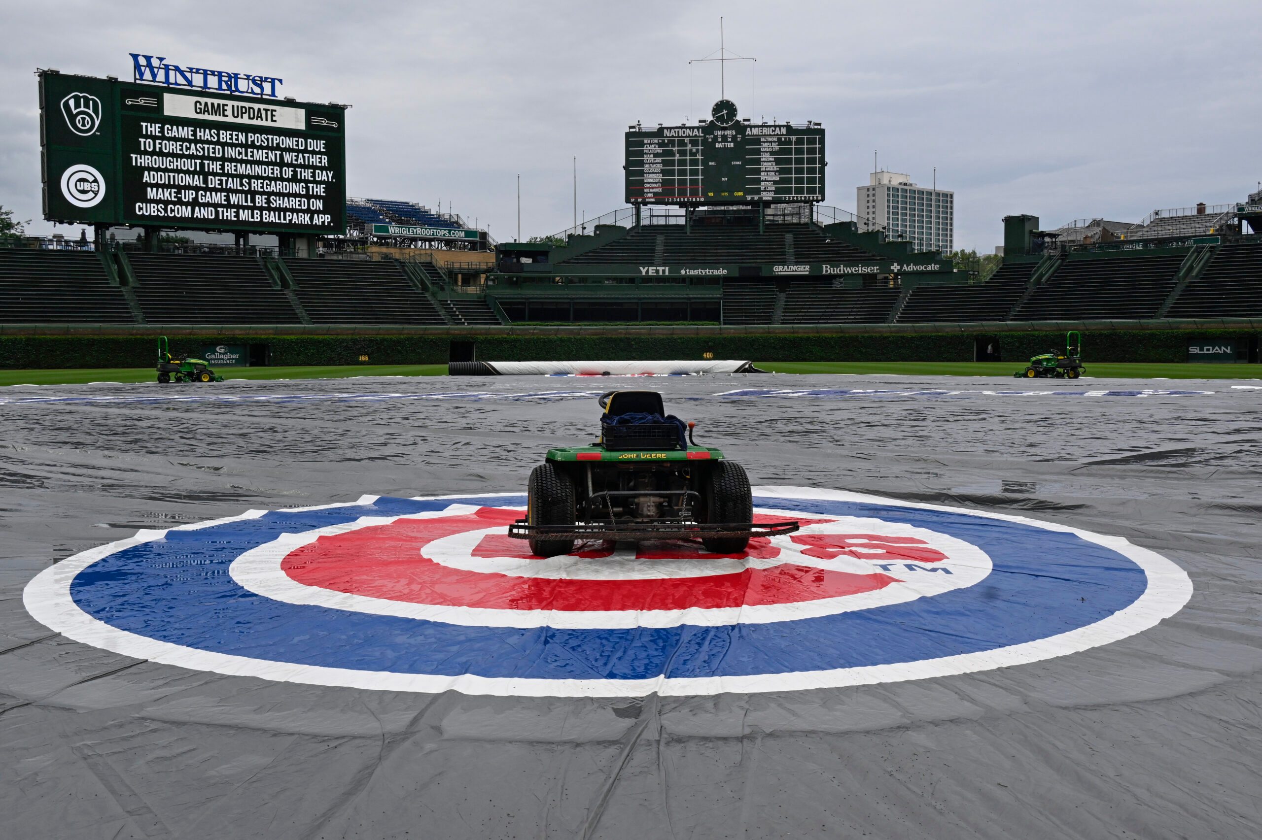Jun 18, 2025; Chicago, Illinois, USA;  The tarp covers the field  before the weather cancelled game between the Chicago Cubs and the Milwaukee Brewers at Wrigley Field. Mandatory Credit: Matt Marton-Imagn Images