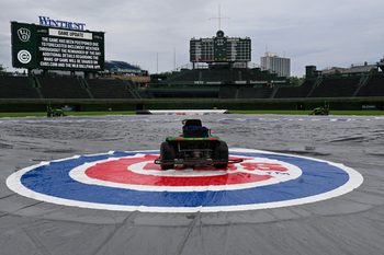 Jun 18, 2025; Chicago, Illinois, USA;  The tarp covers the field  before the weather cancelled game between the Chicago Cubs and the Milwaukee Brewers at Wrigley Field. Mandatory Credit: Matt Marton-Imagn Images