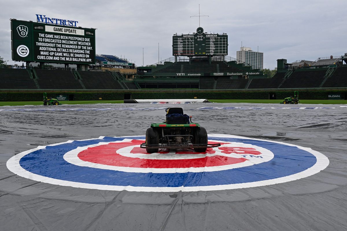 Jun 18, 2025; Chicago, Illinois, USA; The tarp covers the field before the weather cancelled game between the Chicago Cubs and the Milwaukee Brewers at Wrigley Field. Mandatory Credit: Matt Marton-Imagn Images