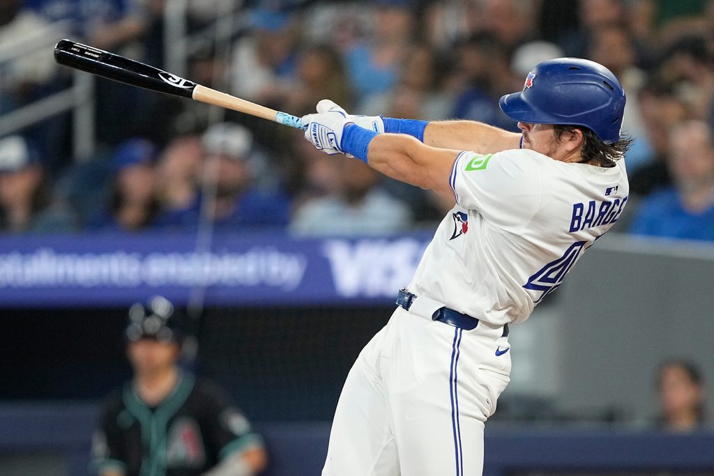 Jun 18, 2025; Toronto, Ontario, CAN; Toronto Blue Jays right fielder Addison Barger (47) hits and RBI double against the Arizona Diamondbacks during the sixth inning at Rogers Centre. Mandatory Credit: John E. Sokolowski-Imagn Images