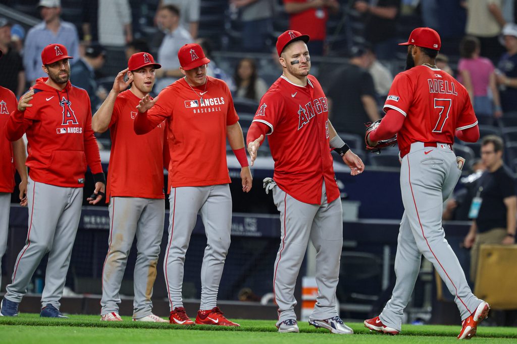 Jun 18, 2025; Bronx, New York, USA; Los Angeles Angels center fielder Jo Adell (7) and designated hitter Mike Trout (27) celebrate with teammates after defeating the New York Yankees at Yankee Stadium. Mandatory Credit: Vincent Carchietta-Imagn Images