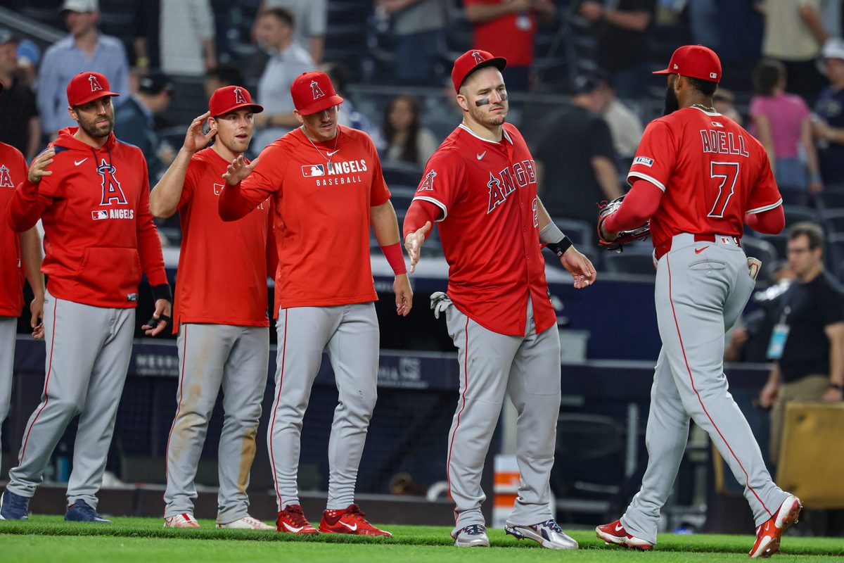 Jun 18, 2025; Bronx, New York, USA; Los Angeles Angels center fielder Jo Adell (7) and designated hitter Mike Trout (27) celebrate with teammates after defeating the New York Yankees at Yankee Stadium. Mandatory Credit: Vincent Carchietta-Imagn Images