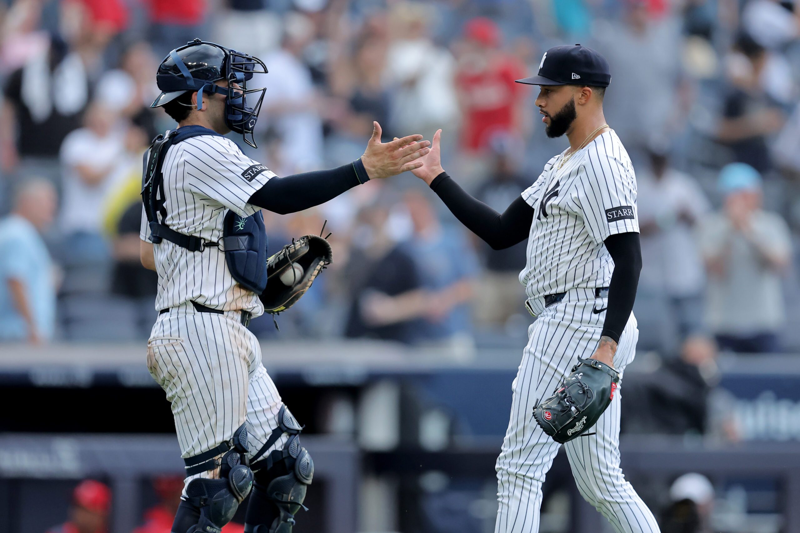 Jun 19, 2025; Bronx, New York, USA; New York Yankees catcher Austin Wells (28) and relief pitcher Devin Williams (38) celebrate after defeating the Los Angeles Angels at Yankee Stadium. Mandatory Credit: Brad Penner-Imagn Images