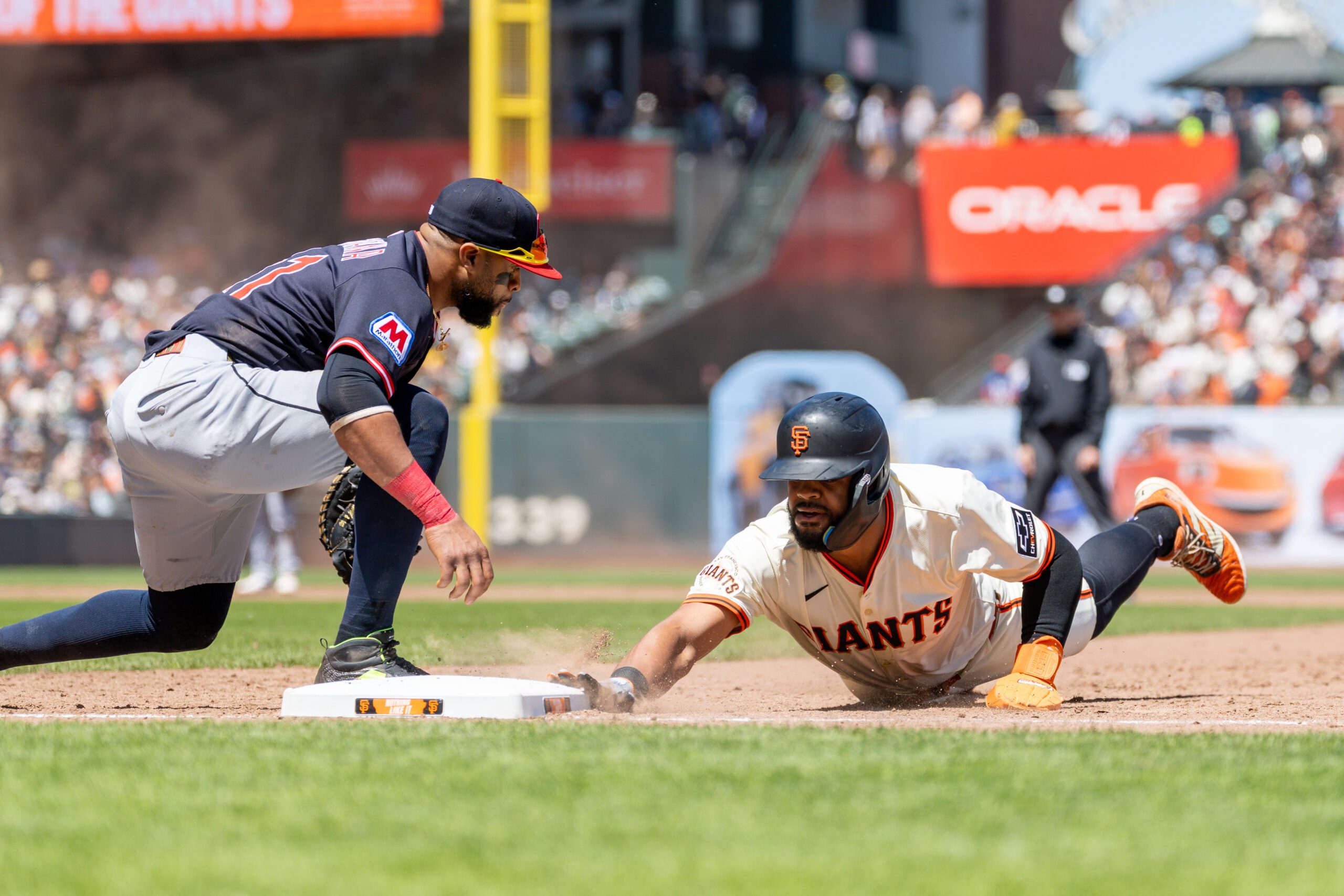Jun 19, 2025; San Francisco, California, USA; San Francisco Giants outfielder Heliot Ramos (17) beats the tag during the sixth inning against the Cleveland Guardians at Oracle Park. Mandatory Credit: Bob Kupbens-Imagn Images