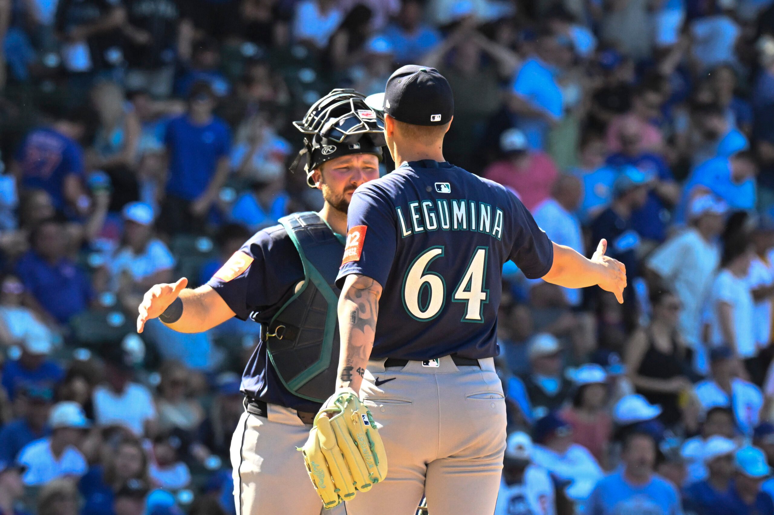 Jun 20, 2025; Chicago, Illinois, USA;  Seattle Mariners catcher Cal Raleigh (29) and pitcher Casey Legumina (64) celebrate after the game asgsinst the Chicago Cubs at Wrigley Field. Mandatory Credit: Matt Marton-Imagn Images