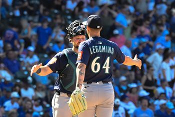 Jun 20, 2025; Chicago, Illinois, USA;  Seattle Mariners catcher Cal Raleigh (29) and pitcher Casey Legumina (64) celebrate after the game asgsinst the Chicago Cubs at Wrigley Field. Mandatory Credit: Matt Marton-Imagn Images
