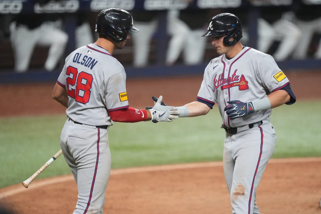 Jun 20, 2025; Miami, Florida, USA; Atlanta Braves first baseman Matt Olson (28) congratulates third baseman Austin Riley, right, on his solo home run in the eighth inning at loanDepot Park. Mandatory Credit: Jim Rassol-Imagn Images