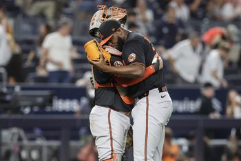 Jun 20, 2025; Bronx, New York, USA;  Baltimore Orioles relief pitcher Félix Bautista (74) celebrates with catcher Gary Sánchez (99) after defeating the New York Yankees 5-3 at Yankee Stadium. Mandatory Credit: Wendell Cruz-Imagn Images