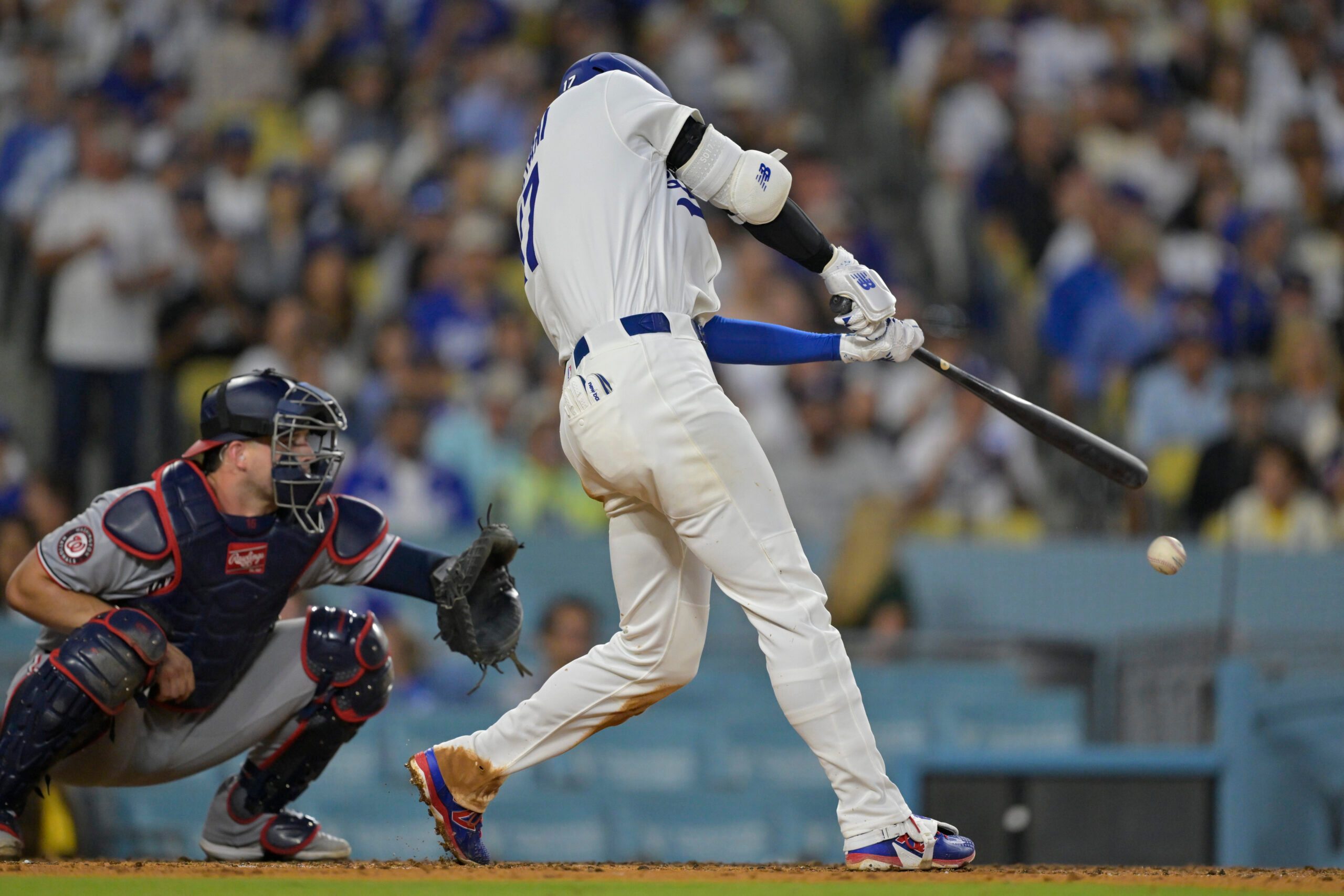 Jun 20, 2025; Los Angeles, California, USA;  Los Angeles Dodgers two-way player Shohei Ohtani (17) hits a RBI single during the fourth inning against the Washington Nationals at Dodger Stadium. Mandatory Credit: Jayne Kamin-Oncea-Imagn Images