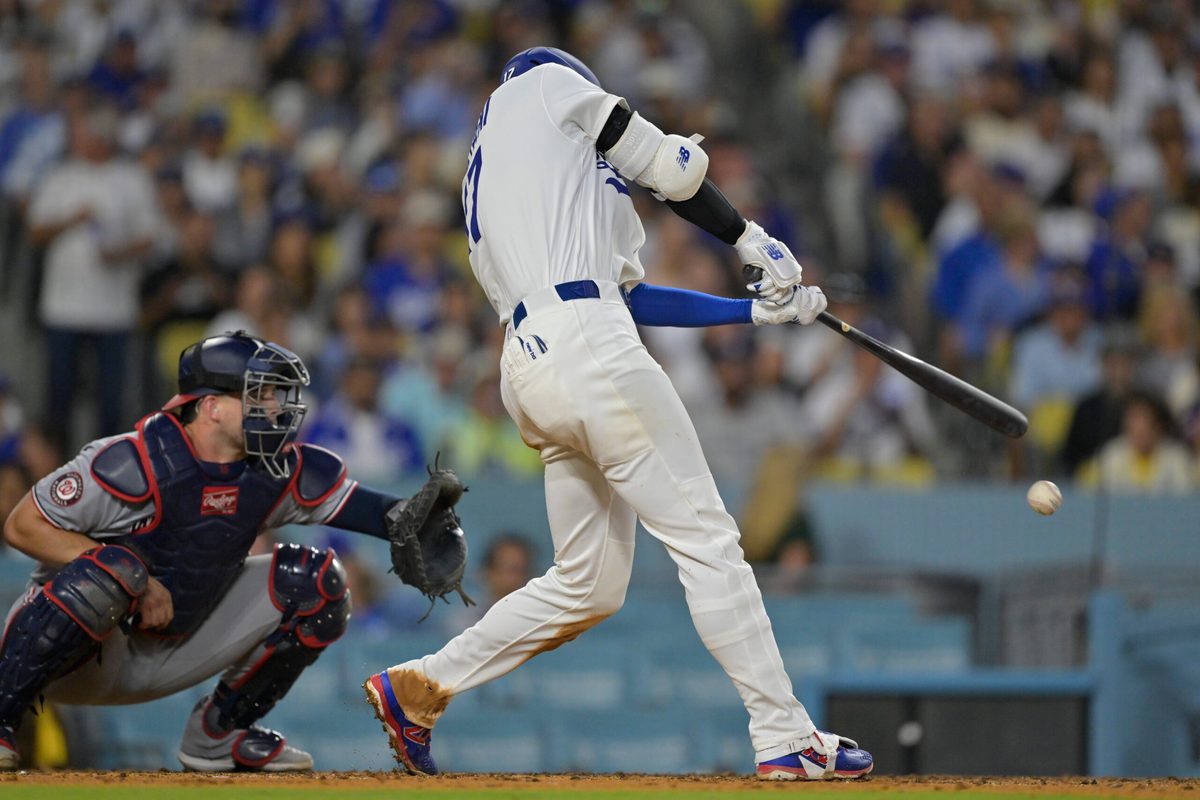 Jun 20, 2025; Los Angeles, California, USA; Los Angeles Dodgers two-way player Shohei Ohtani (17) hits a RBI single during the fourth inning against the Washington Nationals at Dodger Stadium. Mandatory Credit: Jayne Kamin-Oncea-Imagn Images