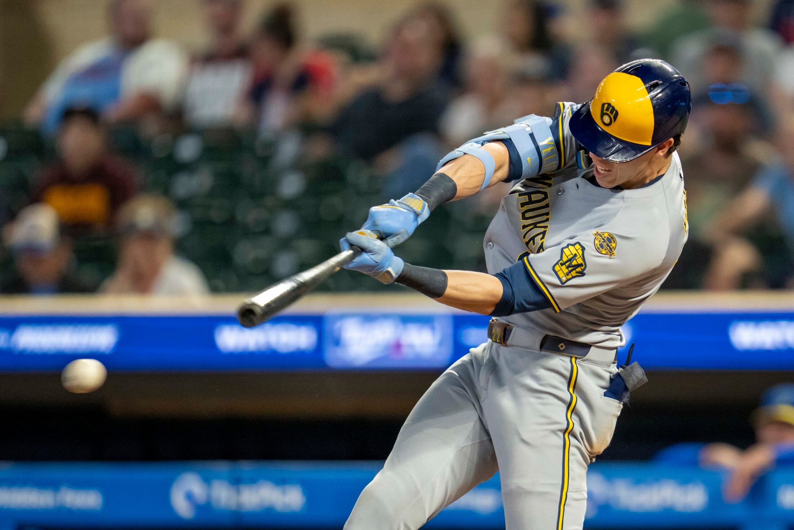 Jun 20, 2025; Minneapolis, Minnesota, USA; Milwaukee Brewers designated hitter Christian Yelich (22) hits a RBI single against the Minnesota Twins in the ninth inning at Target Field. Mandatory Credit: Jesse Johnson-Imagn Images