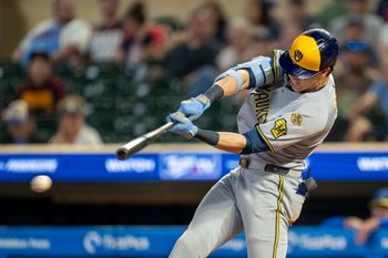 Jun 20, 2025; Minneapolis, Minnesota, USA; Milwaukee Brewers designated hitter Christian Yelich (22) hits a RBI single against the Minnesota Twins in the ninth inning at Target Field. Mandatory Credit: Jesse Johnson-Imagn Images