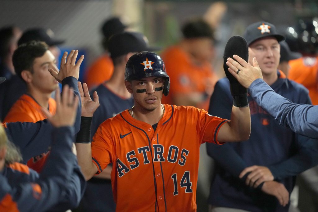 Jun 20, 2025; Anaheim, California, USA; Houston Astros second baseman Mauricio Dubon (14) is congratulated by teammates after scoring in the 10th inning against the Los Angeles Angels at Angel Stadium. Mandatory Credit: Kirby Lee-Imagn Images