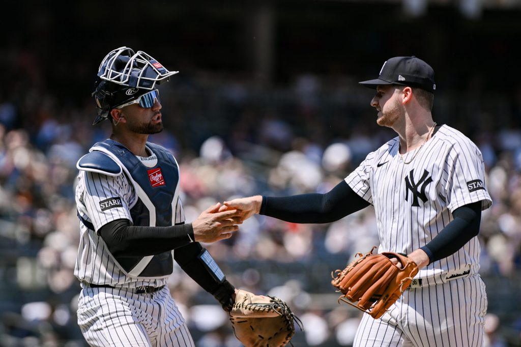 Jun 21, 2025; Bronx, New York, USA; New York Yankees pitcher Clarke Schmidt (36) is greeted by catcher J.C. Escarra (25) after the fourth inning against the Baltimore Orioles at Yankee Stadium. Mandatory Credit: John Jones-Imagn Images