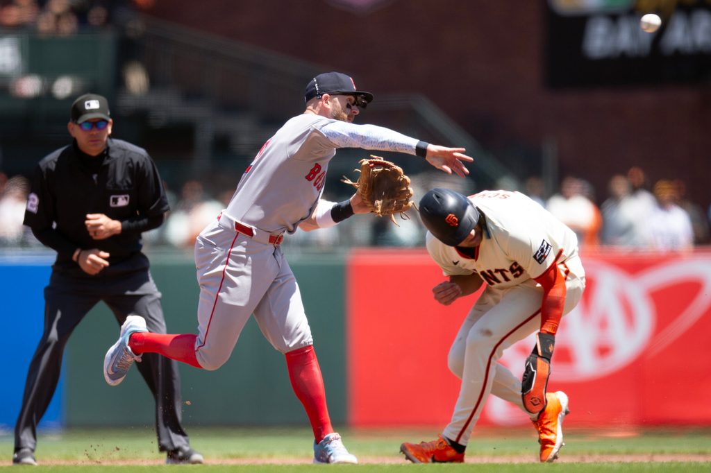 Jun 21, 2025; San Francisco, California, USA; Boston Red Sox shortstop Trevor Story (10) throws over San Francisco Giants third baseman Casey Schmitt (10) too late to complete a double play during the fourth inning at Oracle Park. Mandatory Credit: D. Ross Cameron-Imagn Images