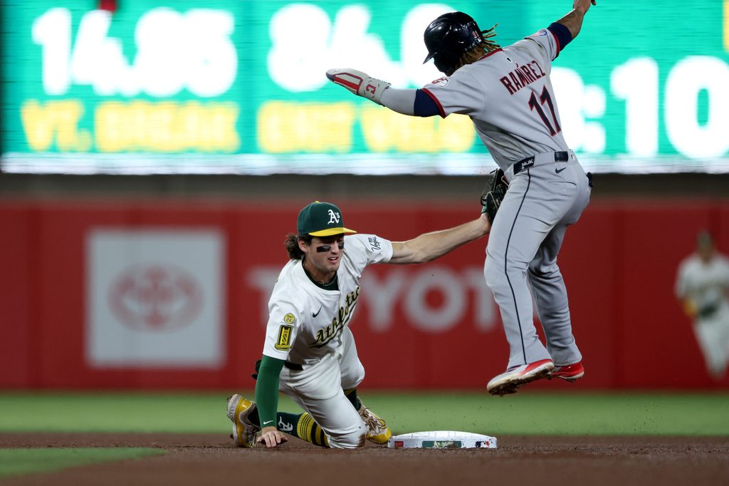 Jun 21, 2025; West Sacramento, California, USA; Athletics shortstop Jacob Wilson (5) tags Cleveland Guardians third baseman Jose Ramirez (11) for an out during the seventh inning at Sutter Health Park. Mandatory Credit: Dennis Lee-Imagn Images