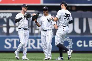 Jun 22, 2025; Bronx, New York, USA; New York Yankees left fielder Cody Bellinger (35) celebrates with center fielder Trent Grisham (12) and right fielder Aaron Judge (99) after defeating the Baltimore Orioles at Yankee Stadium. Mandatory Credit: Vincent Carchietta-Imagn Images