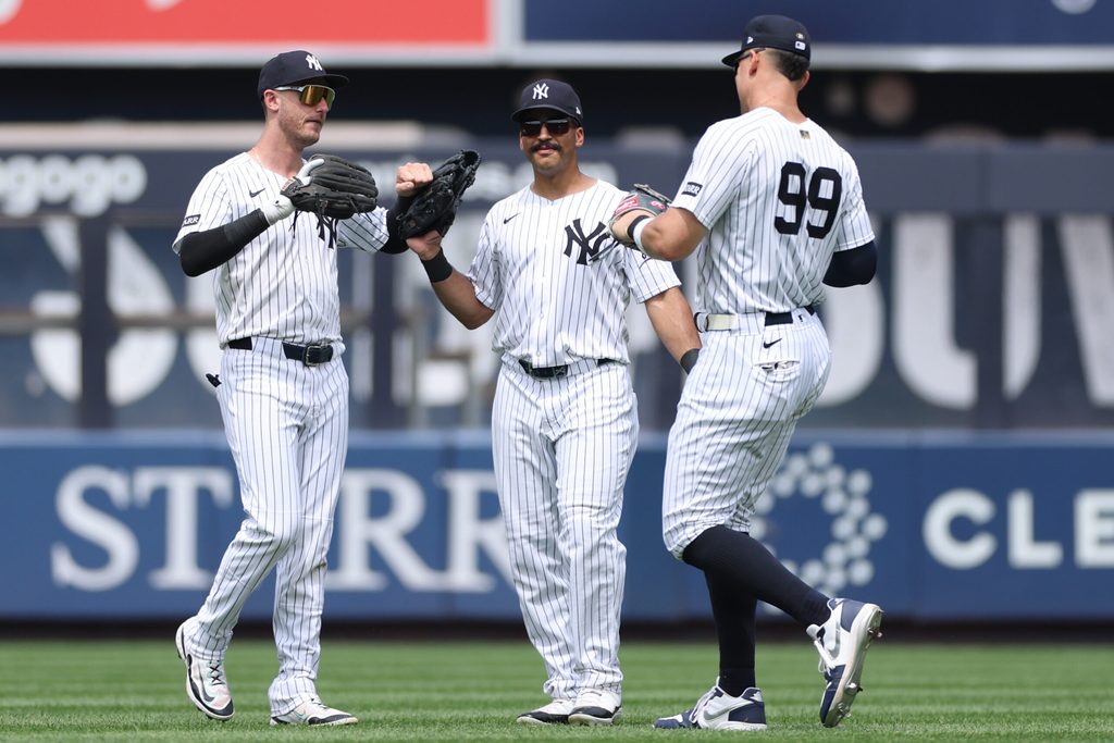 Jun 22, 2025; Bronx, New York, USA; New York Yankees left fielder Cody Bellinger (35) celebrates with center fielder Trent Grisham (12) and right fielder Aaron Judge (99) after defeating the Baltimore Orioles at Yankee Stadium. Mandatory Credit: Vincent Carchietta-Imagn Images
