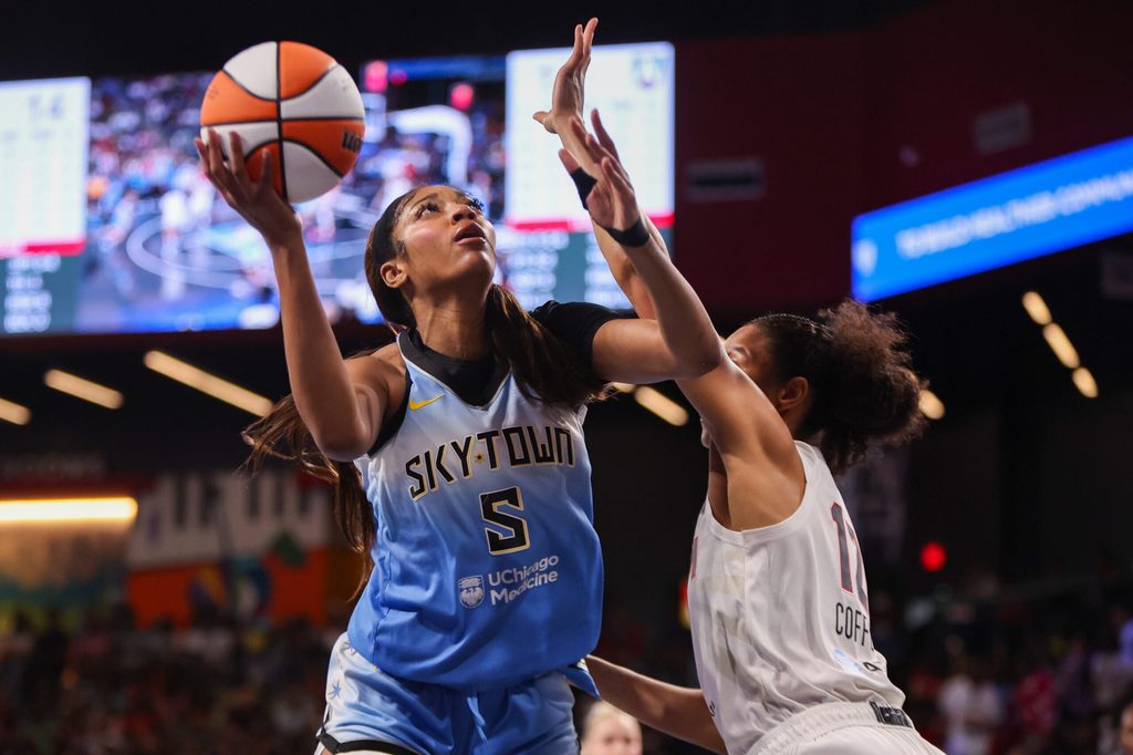 Jun 22, 2025; College Park, Georgia, USA; Chicago Sky forward Angel Reese (5) shoots past Atlanta Dream forward Nia Coffey (12) in the first quarter at Gateway Center Arena at College Park. Mandatory Credit: Brett Davis-Imagn Images
